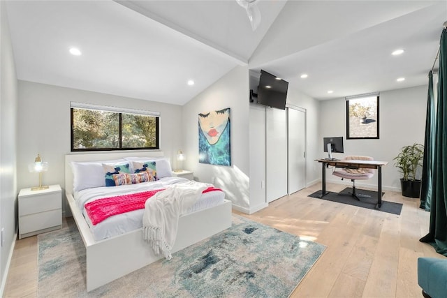 bedroom with lofted ceiling, recessed lighting, light wood-style floors, and baseboards