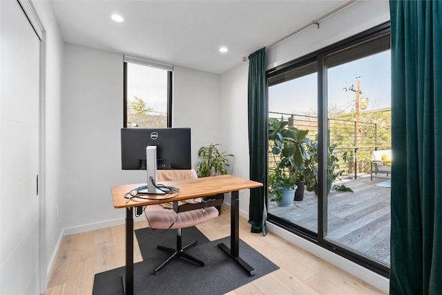 office space featuring recessed lighting, light wood-type flooring, and baseboards