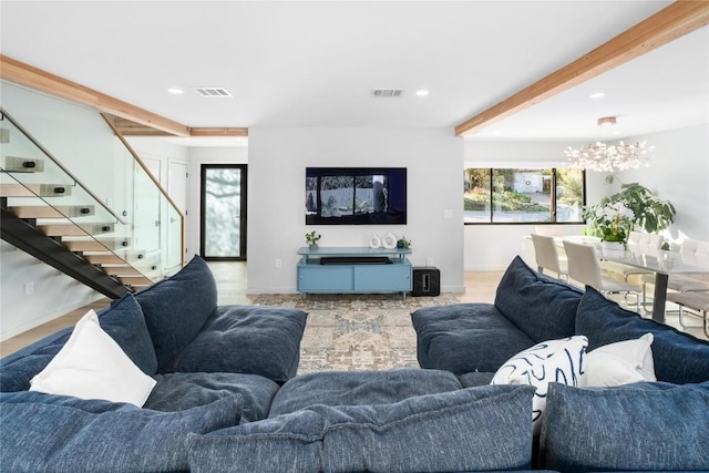 living room with visible vents, beamed ceiling, and a healthy amount of sunlight