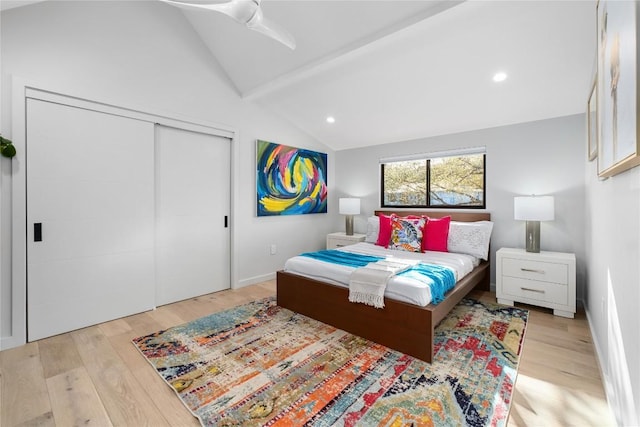 bedroom featuring lofted ceiling, recessed lighting, wood finished floors, and a closet