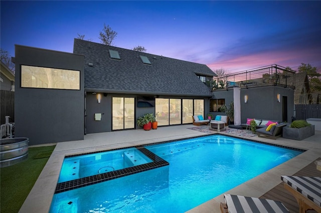 pool at dusk featuring an outdoor living space, a patio, fence, and a pool with connected hot tub