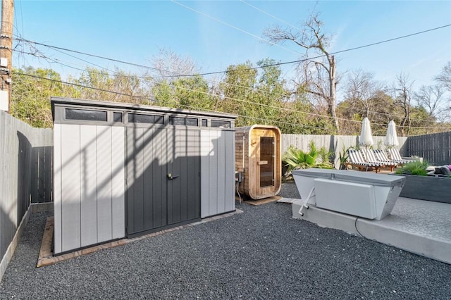 view of shed featuring a fenced backyard