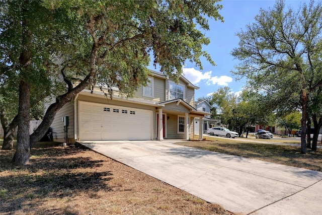 traditional-style home with concrete driveway and a garage