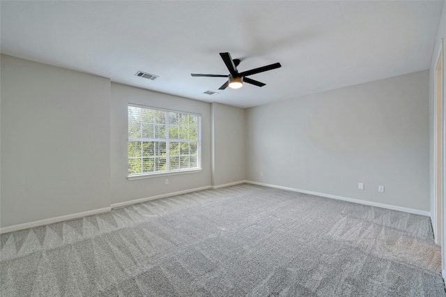 spare room featuring visible vents, baseboards, and carpet floors