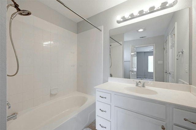 bathroom featuring vanity, visible vents, and shower / bathtub combination