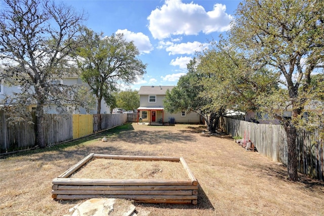 view of yard with a vegetable garden and a fenced backyard