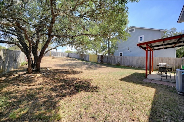 view of yard with cooling unit, a fenced backyard, and a patio area