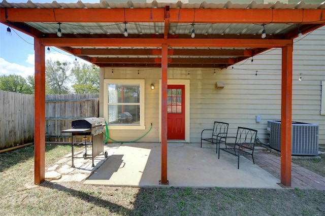 view of patio / terrace featuring central air condition unit and fence