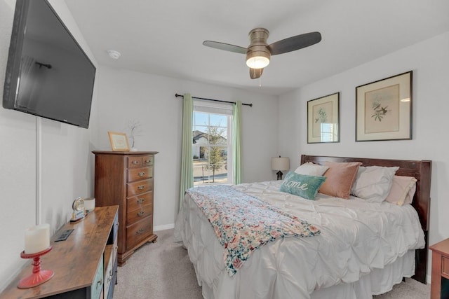 bedroom featuring light colored carpet and ceiling fan