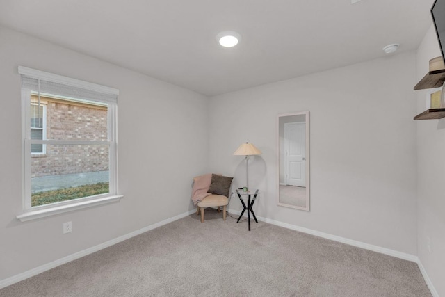 sitting room with baseboards and carpet floors