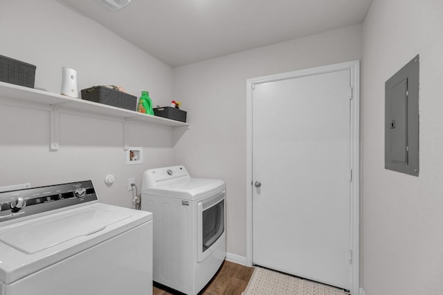 laundry room with electric panel, wood finished floors, laundry area, and washer and clothes dryer