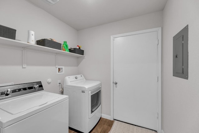 19425 Abigail Fillmore Rd, Manor, TX 78653 - washroom with electric panel, washing machine and clothes dryer, wood finished floors, and baseboards