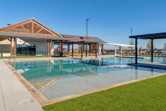 pool with a patio and fence