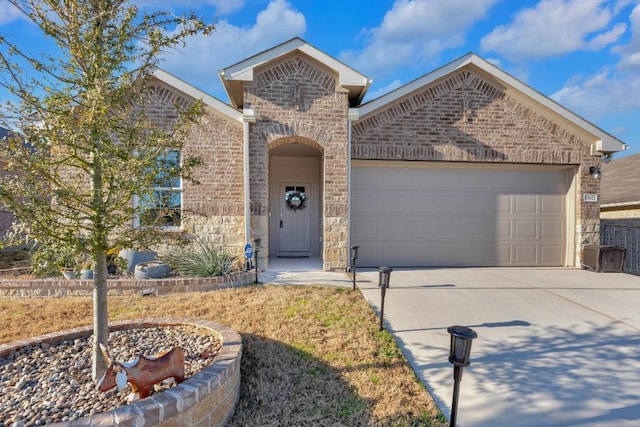 view of front of house featuring brick siding, concrete driveway, and an attached garage