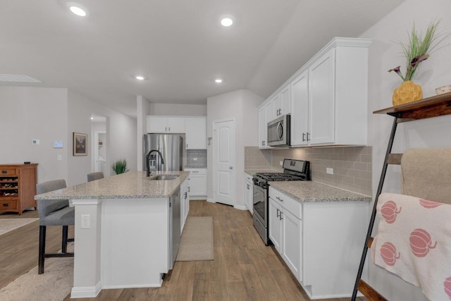 kitchen featuring white cabinetry, light wood-style flooring, and stainless steel appliances