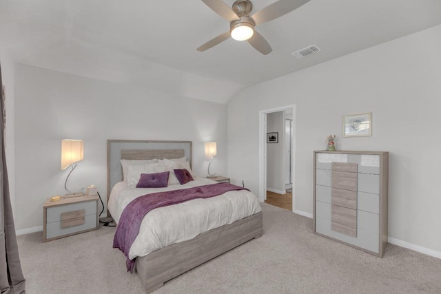 bedroom with visible vents, lofted ceiling, baseboards, and carpet flooring