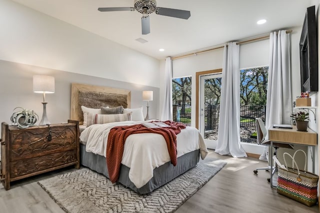 bedroom featuring access to exterior, recessed lighting, wood finished floors, and ceiling fan