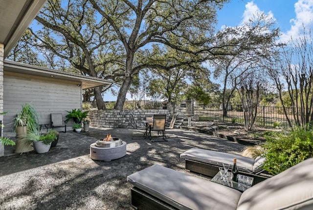 view of patio / terrace with an outdoor fire pit and fence