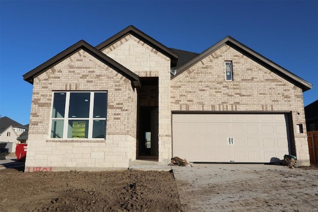 view of front of home featuring brick siding and an attached garage