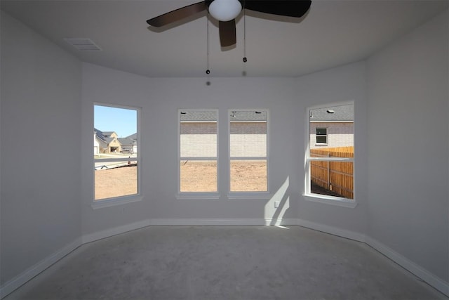 empty room with baseboards, concrete flooring, and ceiling fan