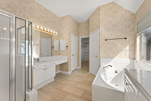 3405 Mulberry Creek Dr, Austin, TX 78732 - full bath with vanity, a whirlpool tub, a stall shower, wood finished floors, and a walk in closet
