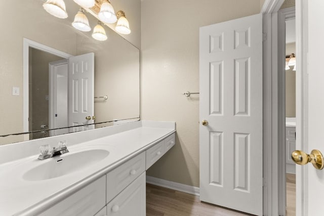 3405 Mulberry Creek Dr, Austin, TX 78732 - bathroom with wood finished floors, vanity, and baseboards