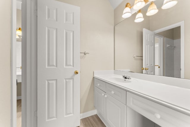 3405 Mulberry Creek Dr, Austin, TX 78732 - full bath with vanity, wood finished floors, a chandelier, baseboards, and a shower