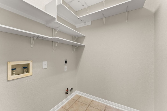 3405 Mulberry Creek Dr, Austin, TX 78732 - laundry area featuring washer hookup, hookup for a gas dryer, baseboards, hookup for an electric dryer, and light tile patterned floors