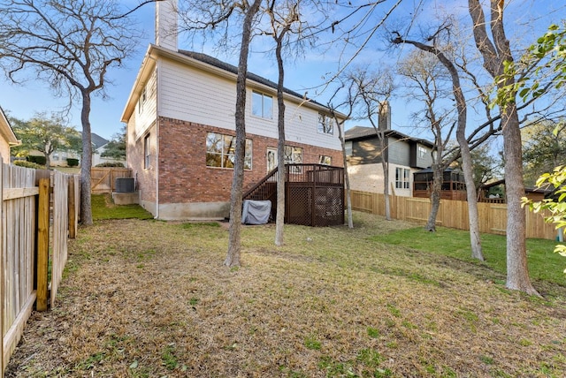 3405 Mulberry Creek Dr, Austin, TX 78732 - back of property with brick siding, central AC, a chimney, and a deck