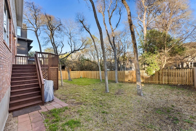 view of yard featuring stairway, a wooden deck, and a fenced backyard