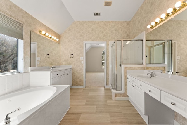 full bathroom with a sink, visible vents, a stall shower, and vaulted ceiling