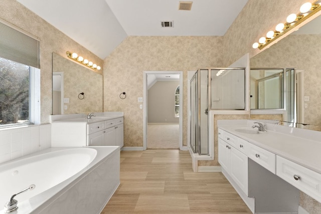 3405 Mulberry Creek Dr, Austin, TX 78732 - full bath featuring vaulted ceiling, two vanities, a garden tub, a shower stall, and baseboards