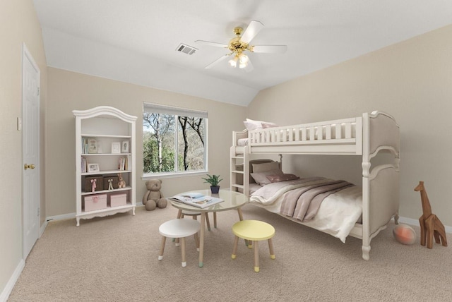 carpeted bedroom featuring visible vents, ceiling fan, baseboards, and vaulted ceiling