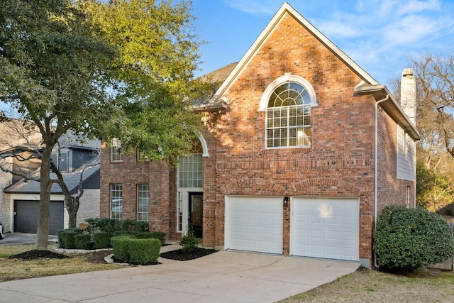 view of front of property featuring a garage, brick siding, concrete driveway, and a chimney