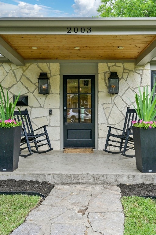 doorway to property featuring a porch