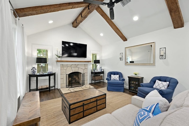 living area with wood finished floors, visible vents, lofted ceiling with beams, a fireplace, and recessed lighting