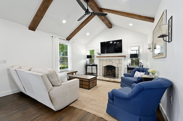 living room with baseboards, lofted ceiling with beams, a fireplace, wood finished floors, and a ceiling fan