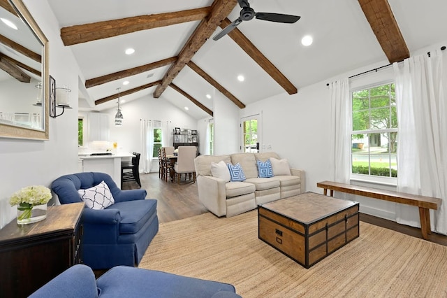 living room featuring a wealth of natural light, lofted ceiling with beams, wood finished floors, and recessed lighting