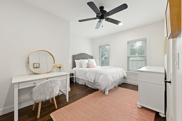 bedroom featuring baseboards, dark wood-style floors, and a ceiling fan