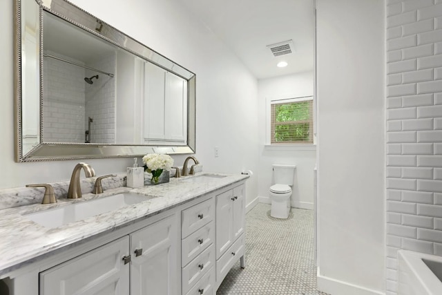 bathroom with tile patterned floors, toilet, visible vents, and a sink