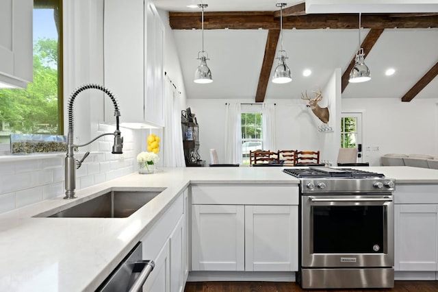 kitchen featuring a sink, decorative backsplash, light countertops, and stainless steel appliances