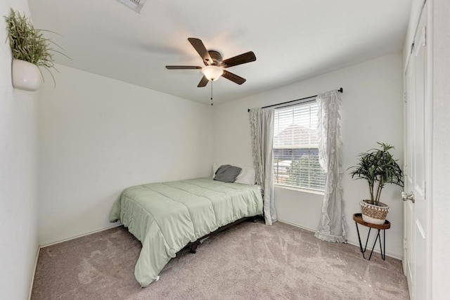 bedroom featuring light carpet and ceiling fan