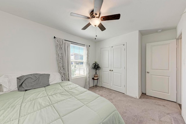 carpeted bedroom featuring a ceiling fan and a closet