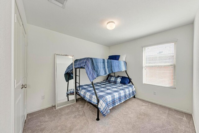 bedroom featuring carpet flooring and visible vents