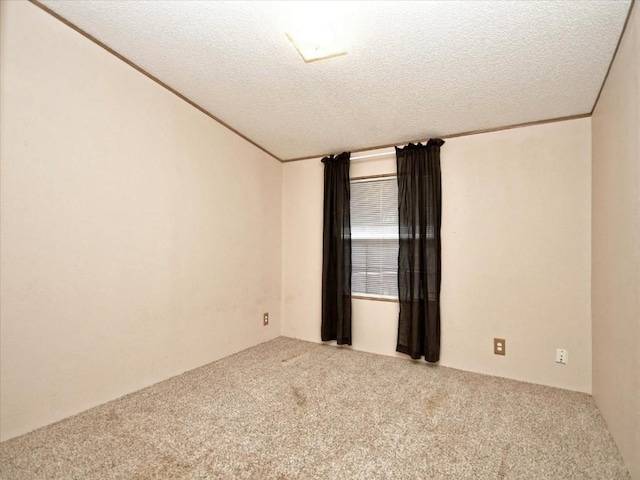 carpeted spare room with a textured ceiling and crown molding