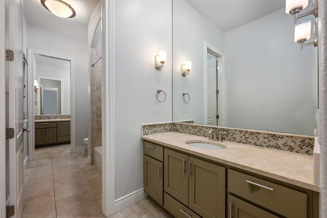 full bathroom featuring toilet, tasteful backsplash, tile patterned flooring, walk in shower, and vanity