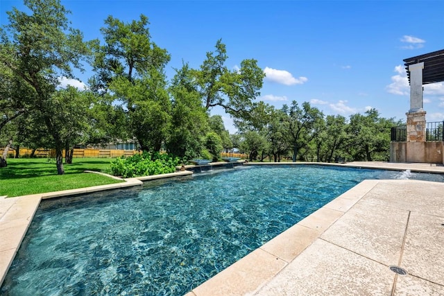 outdoor pool featuring a lawn and fence