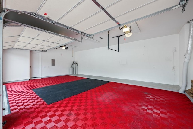 garage with electric panel, a garage door opener, and baseboards