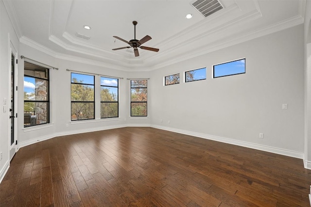 unfurnished room with visible vents, a raised ceiling, dark wood-type flooring, and ornamental molding