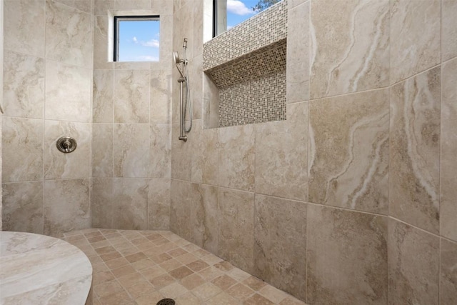 bathroom featuring a tile shower